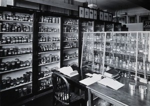 view The Wellcome Building, Euston Road, London: working area in the materia medica stores. Photograph.