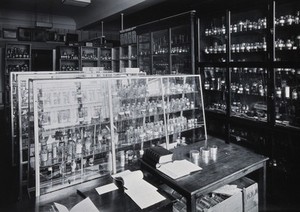 view The Wellcome Building, Euston Road, London: working area in the materia medica stores. Photograph.