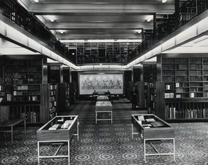 view The Wellcome Building, Euston Road, London: the Reading Room after reconstruction of the Library in 1962, facing north, towards the Vesalian Screen. Photograph.