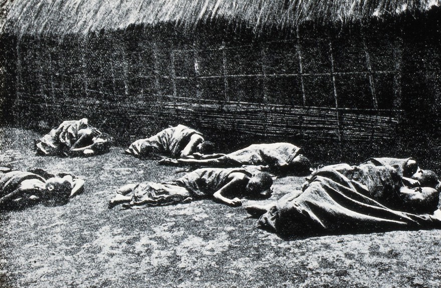 Trypanosomiasis: people with sleeping sickness lying on the ground. Photograph, 19--.