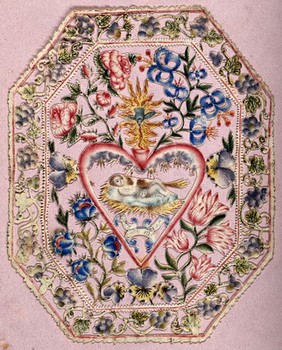 The infant Jesus Christ within a heart, with a coloured filigree border of flowers. Cut paper work and watercolour.