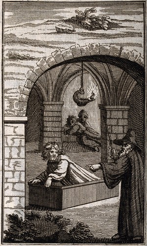 A wizard conjuring a man from his grave. Etching. | Wellcome Collection