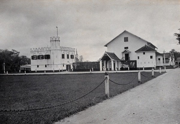 Kuching, Sarawak: a square-towered building and the jail. Photograph.