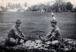 view Sarawak: two Sea Dayaks at a cockfight. Photograph.