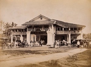 view Malaya: Chinese merchants and carriages outside their club house on Penang Island. Photograph by J. Taylor, 1881.