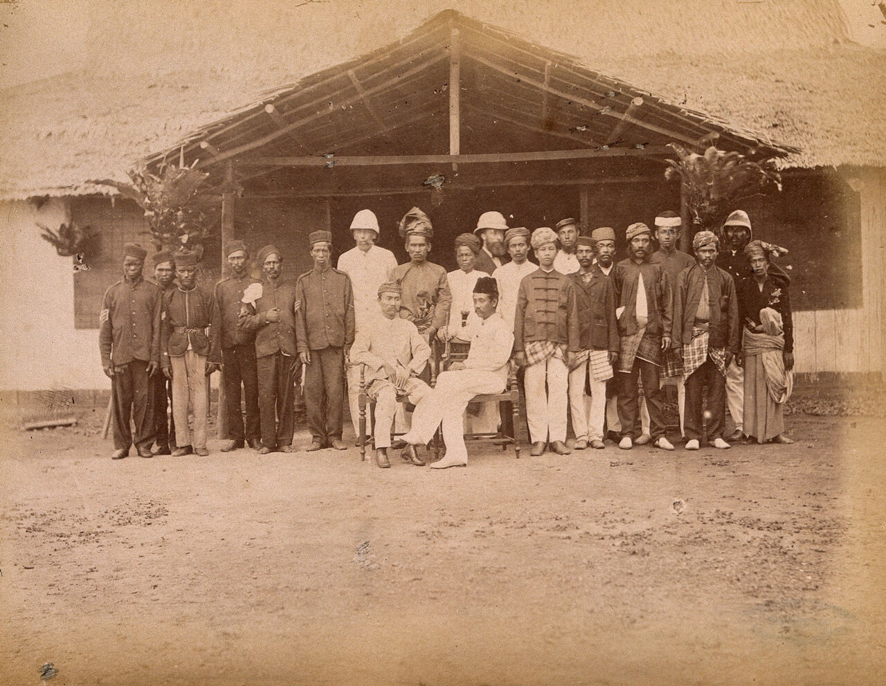 Malaya: two seated Malay dignatories, Tengku Zia Uddin and Raja Ismail, surrounded by their staff and Klang Police. Photograph by J. Birch, 1874., 1880, by James W. W. Birch