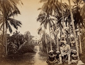 view Singapore: a western hunter and native Malays with a background view of the Roman Catholic Mission Church at Bukit Timah. Photograph by J. Taylor, 1880.
