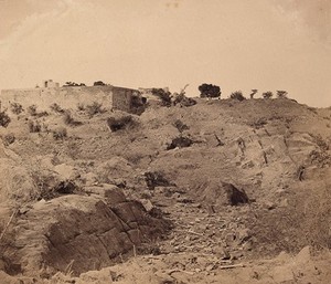 view India: the ruins of Sammy House surrounded by scattered bones of sepoys killed in action. Photograph by F. Beato, c. 1858.