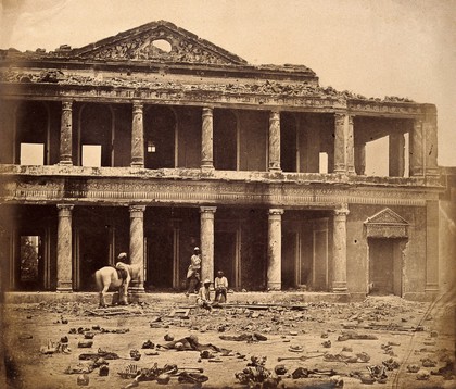 Lucknow, India: the Secundra Bagh interior showing damage done during the Indian Rebellion; skeletons of murdered Indian rebels lie on the ground. Photograph by Felice Beato, ca. 1858.
