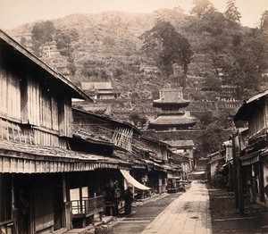 view Nagasaki, Japan: Temple Street, with the cemetery on the hillside in the background. Photograph by Felice Beato, ca. 1868.