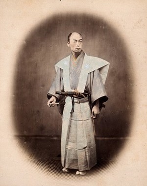 view Japan: a samurai (a 'yakonin') in ceremonial dress. Coloured photograph by Felice Beato, ca. 1868.