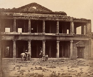 view Lucknow, India: the Secundra Bagh showing damage done during the Indian Rebellion; skeletons of murdered Indian rebels lie on the ground. Photograph by Felice Beato, ca. 1858.