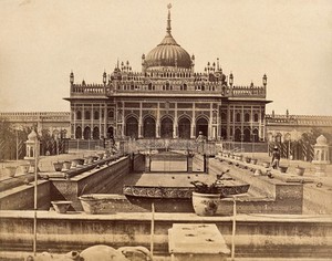 view Lucknow, India: a large emambara with an ornate facade and a domed roof. Photograph by Felice Beato, 1858.