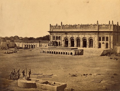 Lucknow, India: an emambara showing damage caused during the Indian Rebellion; soldiers with fighting equipment in the foreground. Photograph by Felice Beato, 1858.