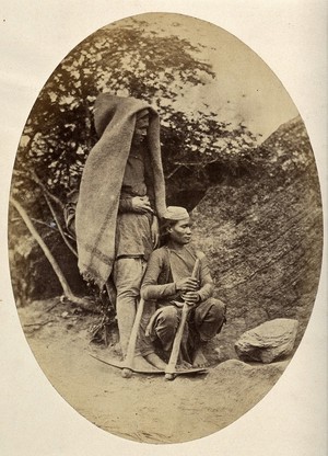 view Nepal: two Tibetan men with pick-axes. Photograph by Clarence Comyn Taylor, ca. 1860.