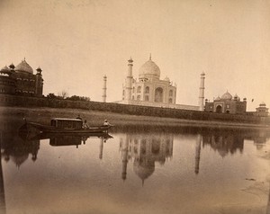 view The Taj Mahal and adjacent buildings, Agra, India; a riverboat in the foreground. Photograph, ca. 1900.