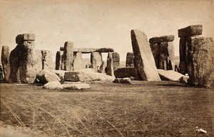 view Stonehenge, England: people walking amongst the stones. Photograph, ca. 1880.