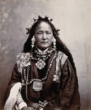 view Ani Chokyi, a Sikkimese/Tibetan woman resident in Darjeeling, wearing elaborate jewellery, costume and head-piece. Photograph by T. Paar, ca. 1890.