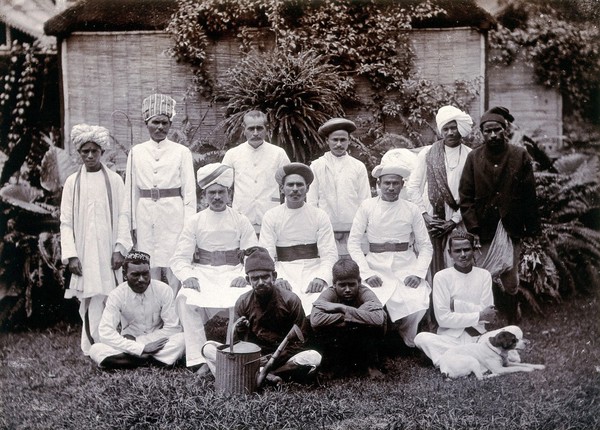 Indian men in white uniforms (domestic staff ?): group portrait. Photograph, ca. 1900.