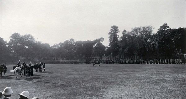 Fort William, Calcutta, India: a military parade to celebrate the presentation of the new colours to the 1st Battalion of the King's Own Regiment. Photograph, 1906.