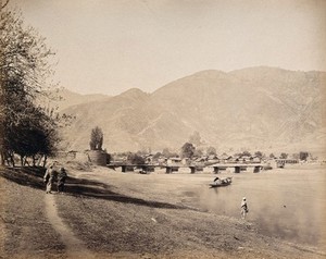 view Baramula, Kashmir: a bridge over the river Jehlum with a town. Photograph by Samuel Bourne.