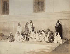 view Kashmir: women in front of a building. Photograph by Samuel Bourne.