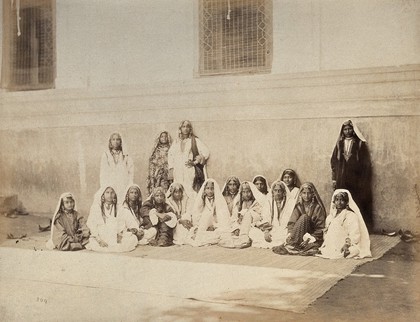 Kashmir: women in front of a building. Photograph by Samuel Bourne.
