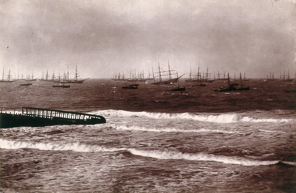 Algoa Bay, South Africa: a bay with pier and ships. Woodburytype, 1888, after a photograph by Robert Harris.