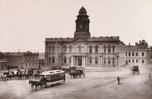 view Port Elizabeth, South Africa: town hall and square with horse-drawn tram. Woodburytype, 1888, after a photograph by Robert Harris.