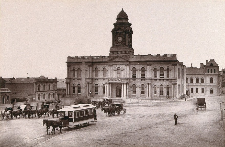 Port Elizabeth, South Africa: town hall and square with horse-drawn tram. Woodburytype, 1888, after a photograph by Robert Harris.