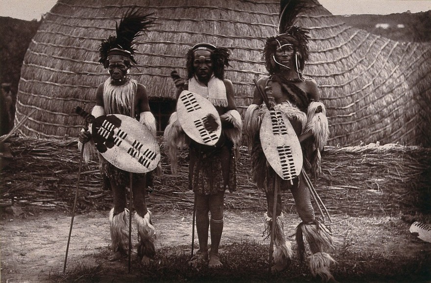 South Africa: three Zulu headmen or chiefs and a kraal. Woodburytype, 1888, after a photograph by Robert Harris.