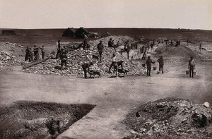 view South Africa: miners at the main reef workings of the Ferreira Gold Mining Company. Woodburytype, 1888, after a photograph by Robert Harris.