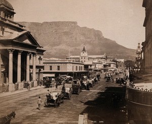 view Cape Town, South Africa: horses and carriages on Adderley Street, with Table Mountain in the background. Photograph by George Washington Wilson, 1896.