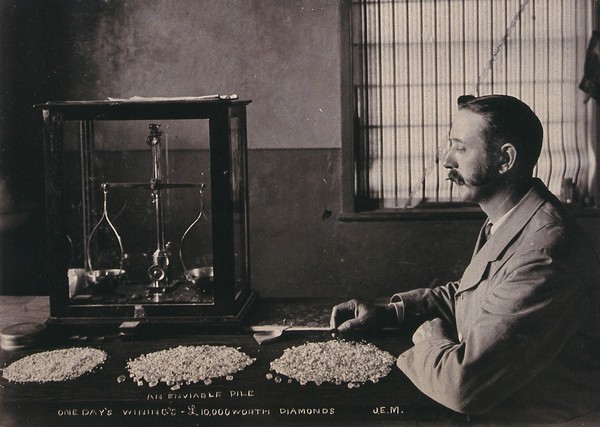 South Africa: an employee of De Beers counting the diamonds mined that day. Photograph by J.E.M., 1896.