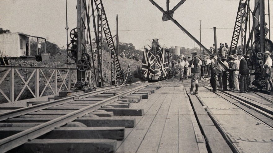 Zimbabwe: people and a flag-covered train at the opening of Victoria Bridge. Photograph by J. Lomas, 1905.