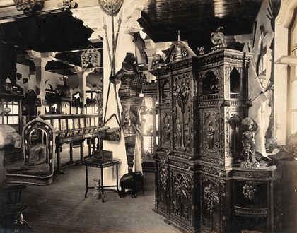 The 1904 World's Fair, St. Louis, Missouri: carved furniture and other decorative items, including a statue of the Buddha, from Ceylon. Photograph, 1904.