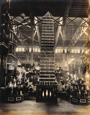 view The 1904 World's Fair, St. Louis, Missouri: the Palace of Agriculture: a tower of olive oil bottles produced by Elwood Cooper. Photograph, 1904.