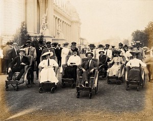 view The 1904 World's Fair, St. Louis, Missouri: visitors in hired wheelchairs, touring the fair pushed by guides. Photograph, 1904.