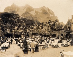 view The 1904 World's Fair, St. Louis, Missouri: the Tyrolean Alps restaurant, showing diners and staff; artificial mountain in the background. Photograph, 1904.