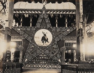 view The 1904 World's Fair, St. Louis, Missouri: the Texas star: a large decorative star with an image of a cowboy at its centre, constructed from Texan agricultural produce. Photograph, 1904.