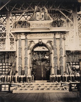 The 1904 World's Fair, St. Louis, Missouri: a Wisconsin agricultural exhibit: a decorated archway bearing the slogan 'We triumph in rye'. Photograph, 1904.