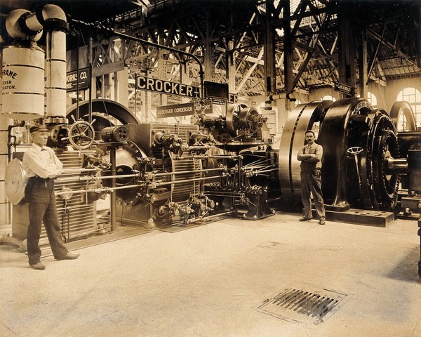 The 1904 World's Fair, St. Louis, Missouri: an engine manufactured by the Crocker-Wheeler company, with two attendants. Photograph, 1904.