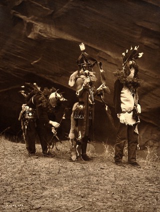 A 'Yebichai Sweat' Navajo medicine ceremony: three Navajos in ceremonial dress with faces masked. Photograph by Edward S. Curtis, 1904.