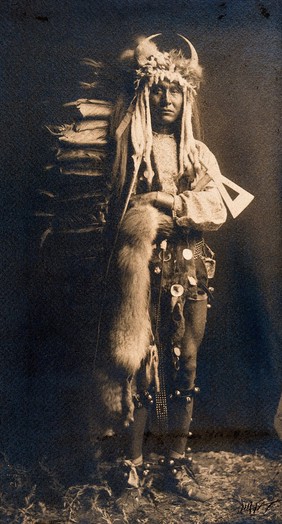 A Piegan man, Iron Breast, in ceremonial dress. Photograph by Edward S. Curtis, 1900.