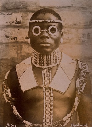 view An African man wearing traditional beadwork. Albumen print.