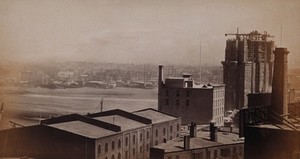 view New York City: rooftops of buildings by the Hudson River. Photograph, ca. 1880.