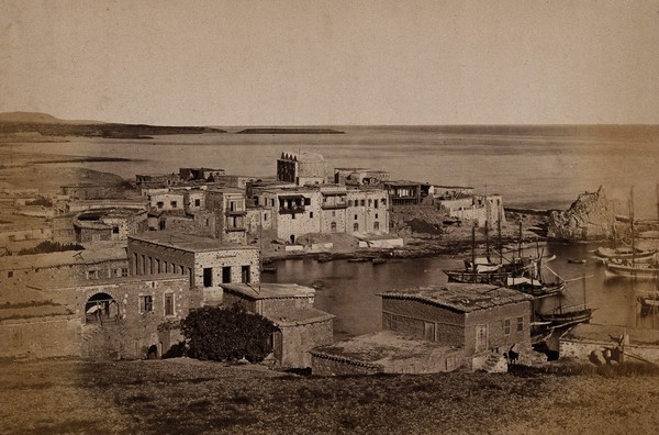 Kyrenia, Cyprus: buildings and boats in the harbour. Photograph, ca. 1880.