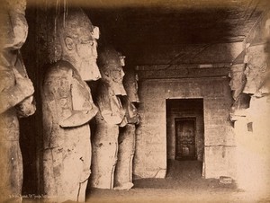 view The Abou Simbel temple (the Sun Temple of Ramesses II), Nubia, Egypt: interior with standing colossi. Photograph by Jean Sébah, ca. 1890.