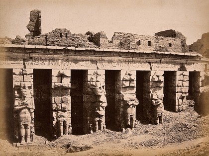 Luxor, Egypt: the Temple of Ramesses III at Medinet Habu: standing colossi in the First Court. Photograph by Pascal Sébah, ca. 1875.