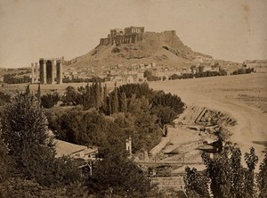 view The Acropolis, Athens, Greece: distant view with the Temple of Olympian Zeus and the Arch of Hadrian in the foreground. Photograph (by Petros Moraites ?), ca. 1870.